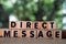 Direct Message word written on wood block