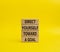 Direct yourself toward a goal symbol. Wooden blocks with words Direct yourself toward a goal. Beautiful yellow background.