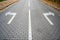 Direction arrows on paved road at intersection, choice concept