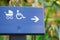 Direction sign for Wheelchair and pram accessible, on dark blue timber.