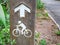 Directional Arrow and Picture Sign of Man Riding Bicycle