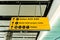 Directional sign at airport, yellow illuminated airport sign
