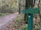 Directional sign on a forest trail. Pointer at the crossroads. Concept: landmark in the park