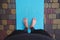 Directly above feet of active man, sportsman yogi standing barefoot on a blue fitness mat while practicing yoga outdoors