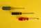 Directly above old screwdrivers on yellow background