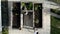 Directly above, over the head view of two women gardening in raised garden beds watering the plants