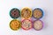 Directly above shot of different breakfast cereals in colorful bowls arranged on table