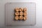 Directly above shot of fresh cookies on cooling rack at table, copy space