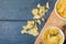 Directly above shot of potato chips in bowl with rosemary on serving board at wooden table