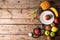 Directly above shot various fruits with stethoscope and heart shape on wooden table with empty space