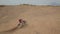 Dirt bike off roading on sand dune