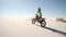 Dirt biker riding his bike across desert