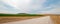 Dirt country road next to uncut Alfalfa field in Montana USA