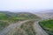 dirt muddy road wet Puddle countryside autumn fall green grass steppe after rain Tire tracks beautiful landscape Moldova