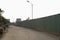 Dirt Road Along Enclosed Corrugated Steel Fence