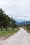 Dirt road along the hill with the traffic sign