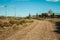 Dirt road coming from the gate of farmstead