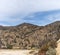 Dirt road curving into desert hills beyond