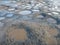 Dirt road full of mud and water ponds