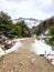 Dirt road with ice in Andes snowy mountain range landscape. Icy forest track. Glaciers and Mountaineering. Landscape and extreme