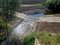 The dirt road leads across a stream that crosses river and continues