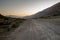 A dirt road leads into a desolate valley