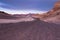 A dirt road leads to the distant beautiful mountains of the atacama desert