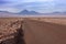 A dirt road leads to the Volcano Licancabur in San Pedro de Atacama