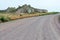 A dirt road passes buttes in southwestern Nebraska