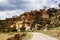 Dirt Road Past Rocky Desert Cliffs