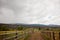 Dirt road on a ranch with a cloudy sky