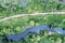 Dirt road between swampy fields and river. wetland landscape in summer. aerial view