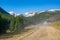 Dirt road to famous Chocholowska Clearing with snowcapped mountains in the background, Tatra Mountains, Poland