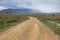 Dirt road to the open mountain range