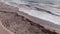 Dirt in sea off the coast of Alanya, Turkey after large storm. Beach with tree debris and plastic garbage after powerful storm. Mu