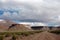 DIRTH ROAD in mountains with overhanging clouds on a sunny day