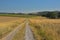 Dirtroad between meadows and corn  fields in the wallonian countryside