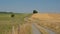 Dirtroad between meadows and fields in the wallonian countryside