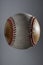 Dirty baseball, white and brown on a gray background