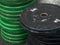 Dirty black and green disc barbell stack