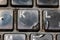 Dirty black slim keyboard from laptop or desktop computer with melted plastic keys from cigarette burns close up