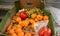 Dirty boxes with rotten tangerines and pepper. Garbage and food waste