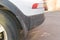 Dirty car side. Fragment of a dirty SUV. Dirty rear wheel and bumper of the off-road car with swamp splashes on a side panel.