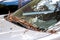 Dirty car windshield with dust covered glass and wipers.