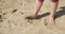 Dirty child feet on sand
