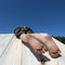 Dirty children feet hang down when child climbs over fence or on roof.