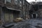 The dirty courtyard of the old factory. Old brick walls and gates