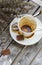 A dirty cup after coffee on a wooden surface.