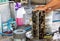 Dirty cylinder head in a stainless steel tray being cleaned by a mechanical with gasoline in a garage. Selective focus on cylinder