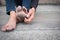 Dirty foot of a man sitting on old concrete floor.